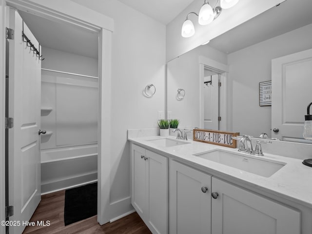 221 Salt Meadow Ln, Newport, NC 28570 - bathroom with wood finished floors, double vanity, baseboards, and bathing tub / shower combination