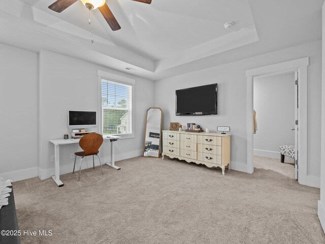 221 Salt Meadow Ln, Newport, NC 28570 - carpeted bedroom with a tray ceiling, ceiling fan, a desk, and baseboards
