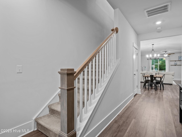 221 Salt Meadow Ln, Newport, NC 28570 - stairway featuring wood finished floors, baseboards, and a chandelier