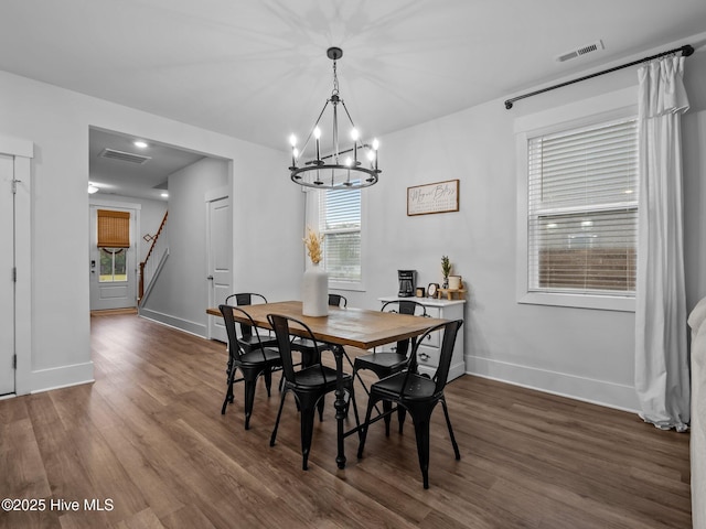 221 Salt Meadow Ln, Newport, NC 28570 - dining room with baseboards, a chandelier, dark wood-style flooring, and stairs