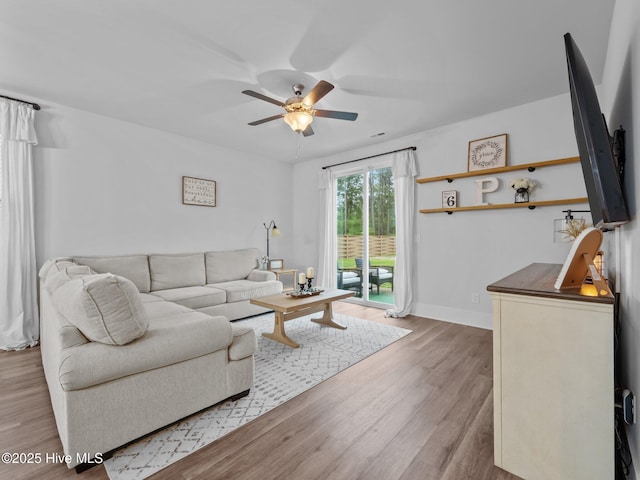 221 Salt Meadow Ln, Newport, NC 28570 - living room featuring ceiling fan, wood finished floors, and baseboards