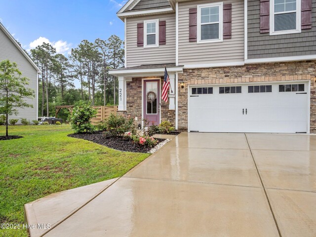 221 Salt Meadow Ln, Newport, NC 28570 - view of front of property featuring stone siding, an attached garage, driveway, and a front lawn