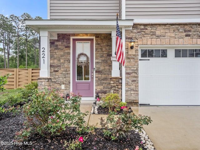 221 Salt Meadow Ln, Newport, NC 28570 - property entrance with stone siding, fence, and concrete driveway