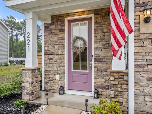 221 Salt Meadow Ln, Newport, NC 28570 - property entrance featuring a porch and stone siding