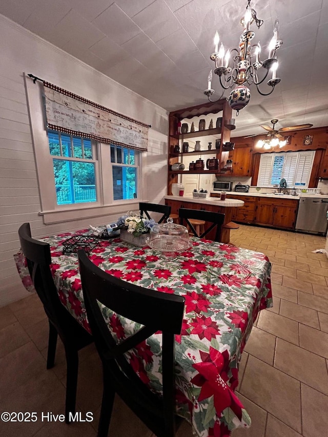 dining space featuring a chandelier, light tile patterned flooring, and a ceiling fan