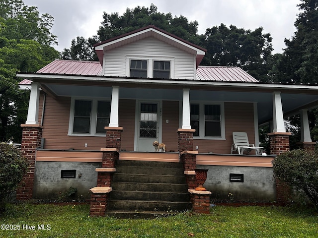 view of front of home featuring covered porch, crawl space, and metal roof
