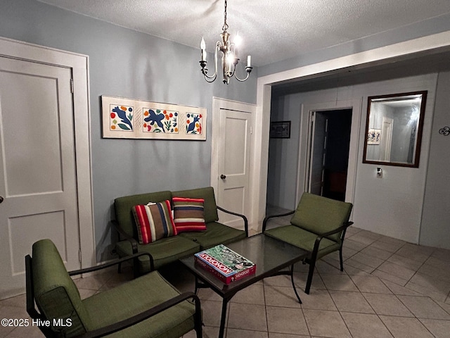 sitting room featuring a textured ceiling, a chandelier, and light tile patterned floors