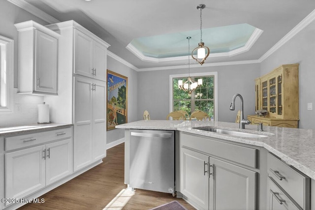 697 Jenoa Loop, Castle Hayne, NC 28429 - kitchen with stainless steel dishwasher, a sink, a raised ceiling, dark wood-type flooring, and pendant lighting