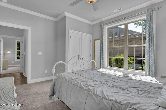 697 Jenoa Loop, Castle Hayne, NC 28429 - bedroom featuring baseboards, carpet flooring, ornamental molding, a closet, and a ceiling fan