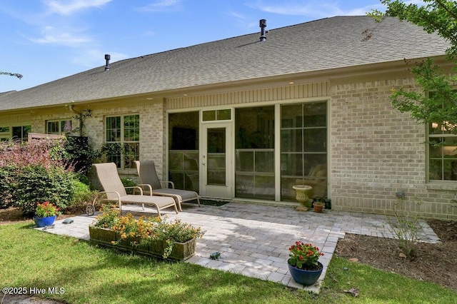 697 Jenoa Loop, Castle Hayne, NC 28429 - rear view of house featuring roof with shingles, a patio, and brick siding