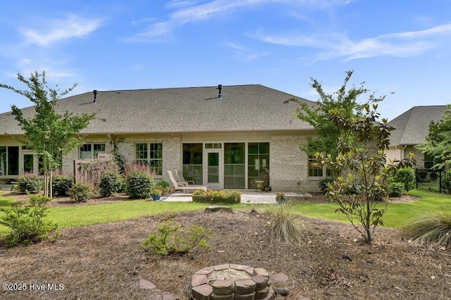697 Jenoa Loop, Castle Hayne, NC 28429 - back of house with a fire pit, brick siding, a shingled roof, and a patio area