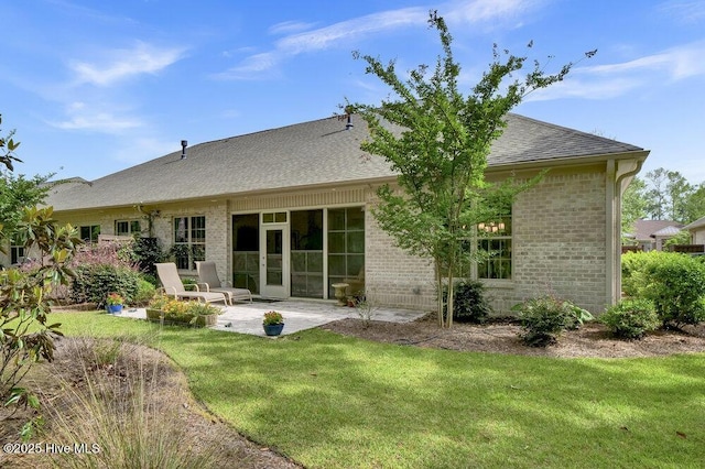 697 Jenoa Loop, Castle Hayne, NC 28429 - rear view of house with brick siding, a patio area, a lawn, and roof with shingles