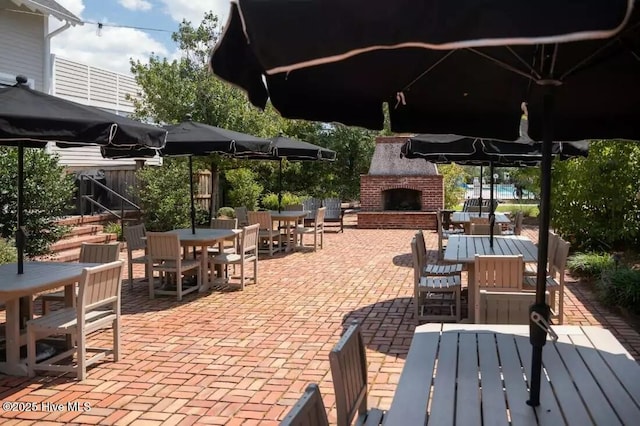 697 Jenoa Loop, Castle Hayne, NC 28429 - view of patio / terrace featuring outdoor dining area and an outdoor brick fireplace