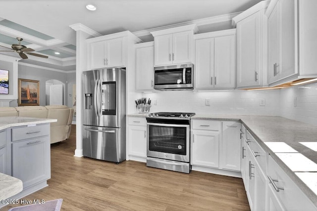 697 Jenoa Loop, Castle Hayne, NC 28429 - kitchen with appliances with stainless steel finishes, crown molding, open floor plan, a ceiling fan, and white cabinets