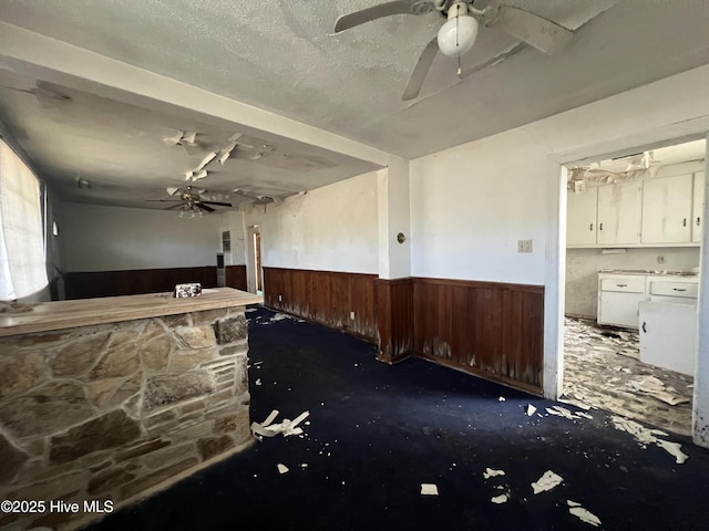 144 Shannonhouse Rd, Edenton, NC 27932 - spare room featuring wainscoting, a ceiling fan, and wood walls