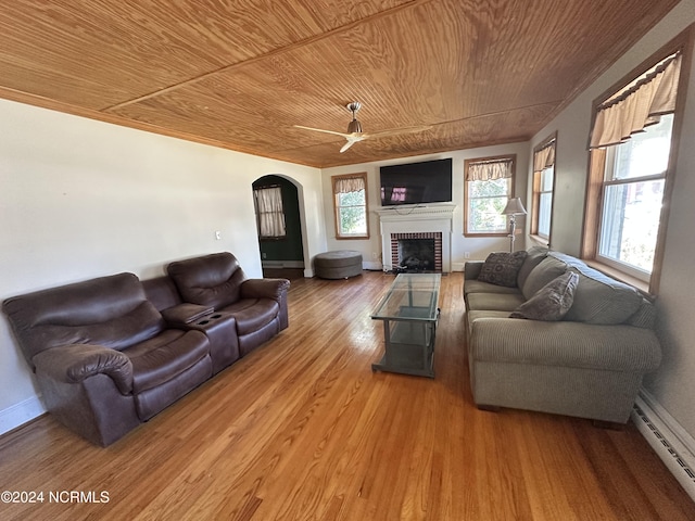 living area featuring wood ceiling, a baseboard heating unit, ceiling fan, arched walkways, and light wood-style floors
