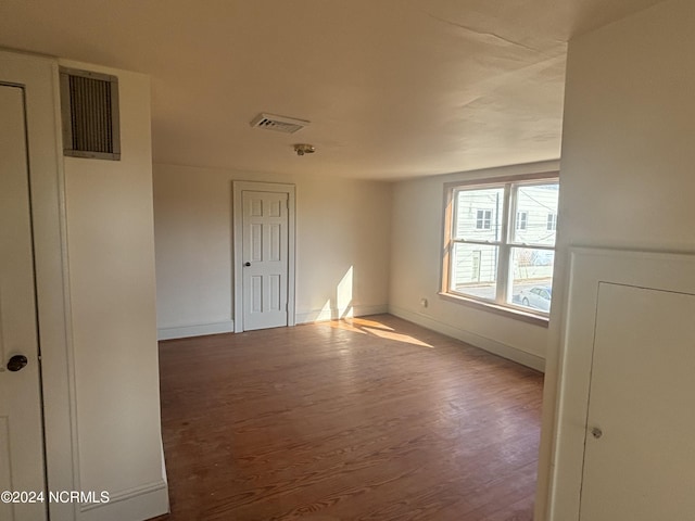 unfurnished room featuring wood finished floors and baseboards