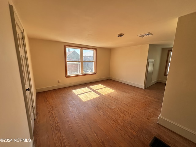 empty room featuring wood finished floors and baseboards