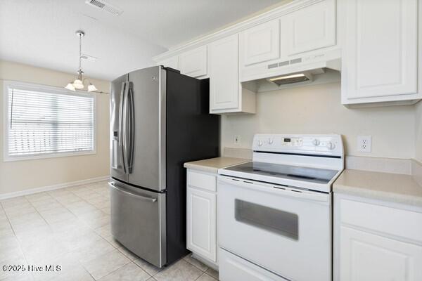 2610 Selkirk Ct, Wilmington, NC 28411 - kitchen with white electric range oven, stainless steel fridge, under cabinet range hood, a chandelier, and light countertops