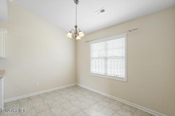 2610 Selkirk Ct, Wilmington, NC 28411 - unfurnished dining area featuring a chandelier and baseboards