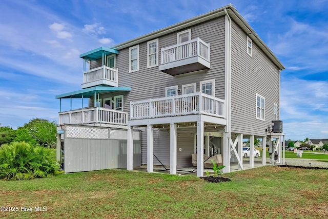 200 Twin Oaks Dr Unit B, Hampstead, NC 28443 - back of property featuring a balcony, a yard, and a patio