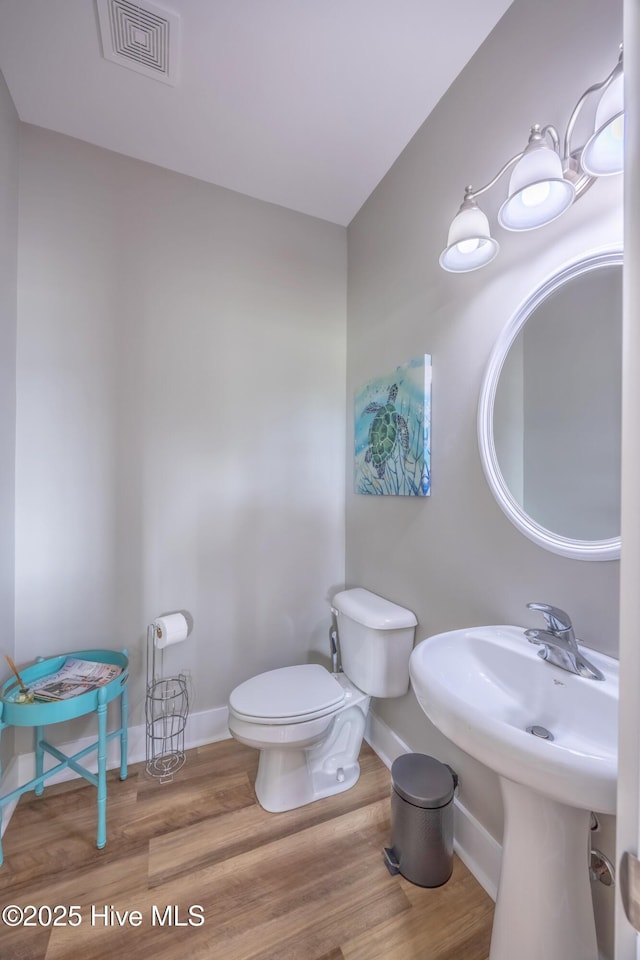 200 Twin Oaks Dr Unit B, Hampstead, NC 28443 - half bathroom featuring baseboards, toilet, and wood finished floors