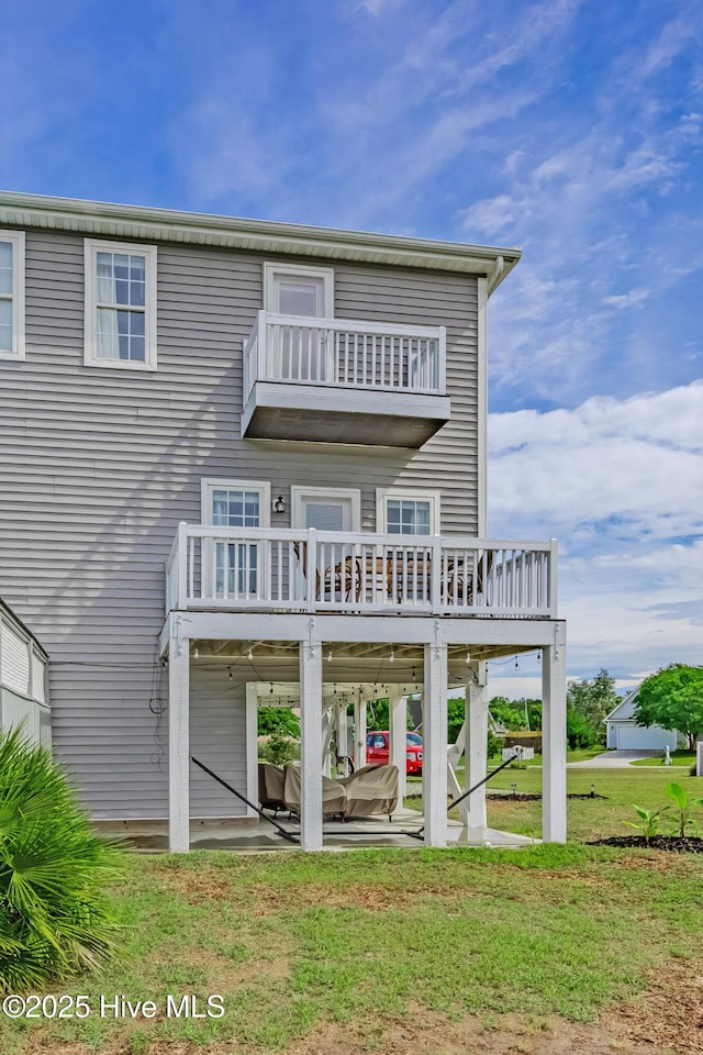 200 Twin Oaks Dr Unit B, Hampstead, NC 28443 - rear view of house with a balcony, a patio, a lawn, and a deck