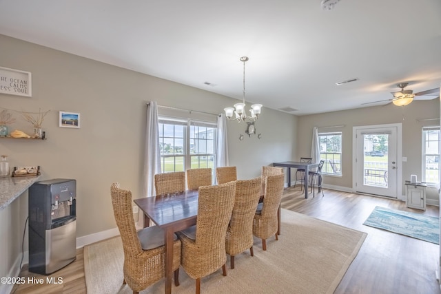 200 Twin Oaks Dr Unit B, Hampstead, NC 28443 - dining space featuring light wood-style floors, plenty of natural light, and a chandelier