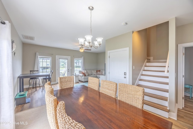 200 Twin Oaks Dr Unit B, Hampstead, NC 28443 - dining area with a chandelier, light wood-type flooring, stairway, and baseboards