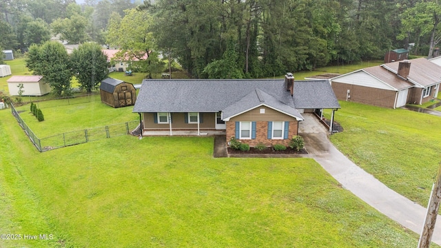 view of front of property featuring a shed, an outdoor structure, a chimney, concrete driveway, and roof with shingles