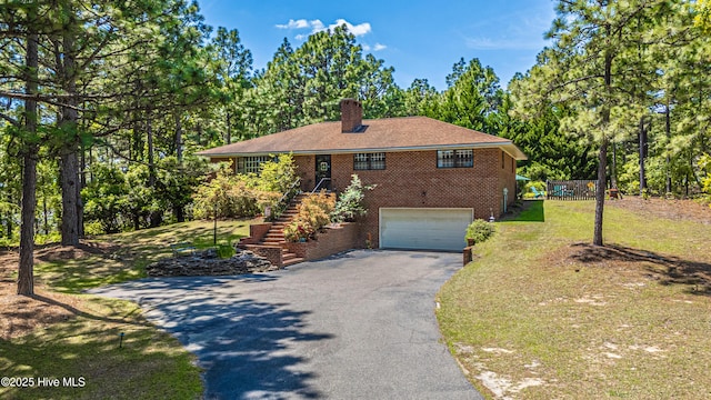 118 Lancashire Ln, West End, NC 27376 - single story home featuring asphalt driveway, brick siding, a chimney, stairway, and a garage