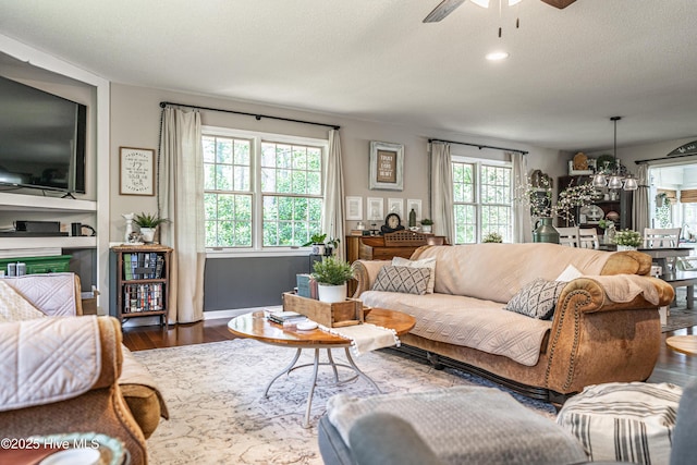 118 Lancashire Ln, West End, NC 27376 - living room with ceiling fan, wood finished floors, healthy amount of natural light, and a chandelier