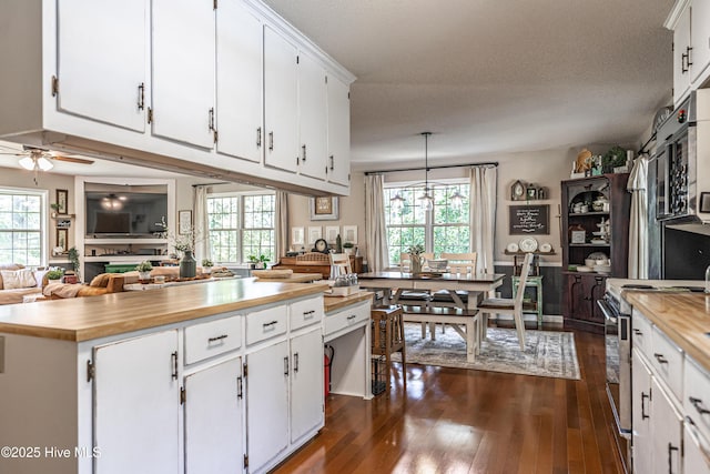 118 Lancashire Ln, West End, NC 27376 - kitchen featuring stainless steel electric range oven, butcher block countertops, white cabinetry, and dark wood-type flooring
