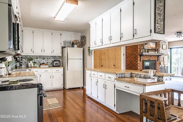 118 Lancashire Ln, West End, NC 27376 - kitchen with freestanding refrigerator, range with electric cooktop, a textured ceiling, dark wood finished floors, and tasteful backsplash