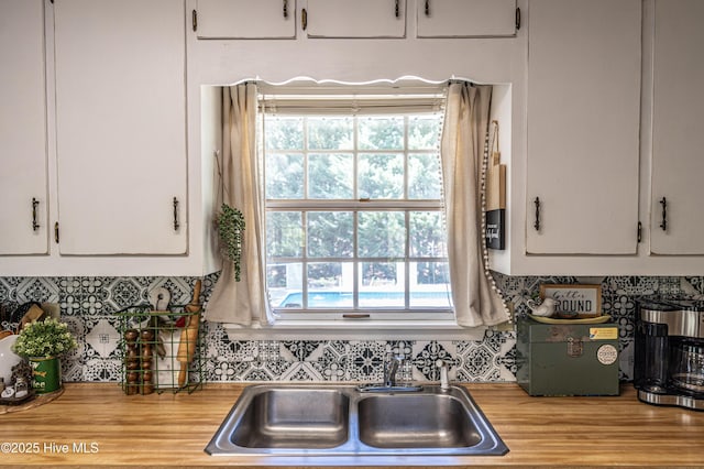 118 Lancashire Ln, West End, NC 27376 - kitchen featuring a sink, white cabinetry, decorative backsplash, wood counters, and wood finished floors