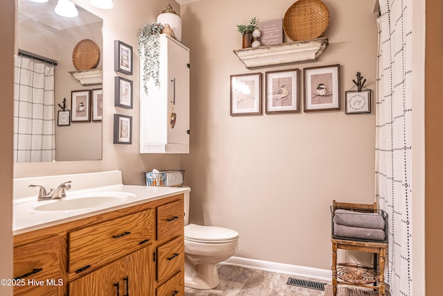 118 Lancashire Ln, West End, NC 27376 - bathroom featuring toilet, vanity, and baseboards