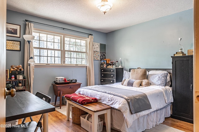 118 Lancashire Ln, West End, NC 27376 - bedroom featuring wood finished floors and a textured ceiling