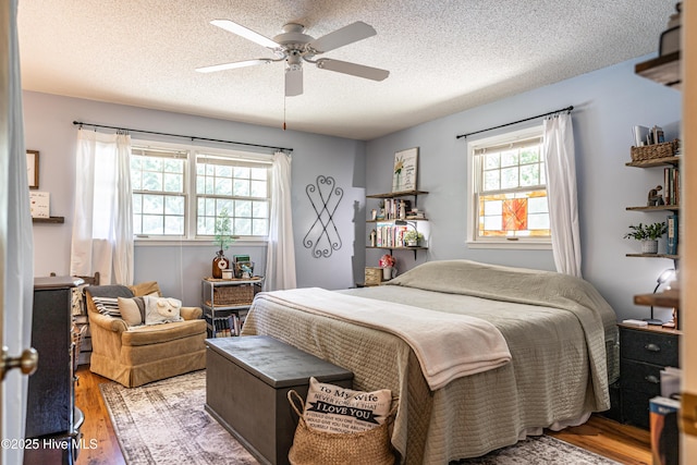 118 Lancashire Ln, West End, NC 27376 - bedroom with wood finished floors, a textured ceiling, and a ceiling fan