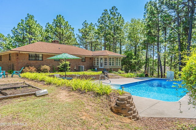 118 Lancashire Ln, West End, NC 27376 - swimming pool with a patio area, central air condition unit, and a vegetable garden