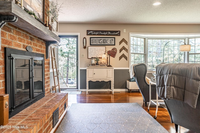 118 Lancashire Ln, West End, NC 27376 - living room featuring wood finished floors, a textured ceiling, recessed lighting, and wainscoting