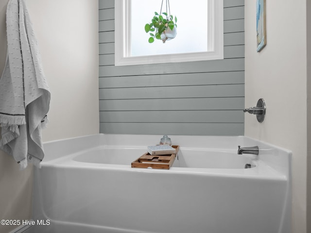 full bath featuring a tub to relax in