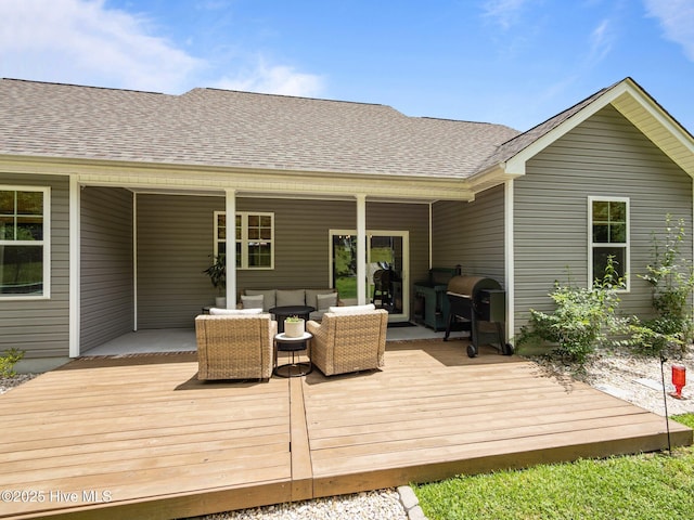 deck with an outdoor hangout area and a grill