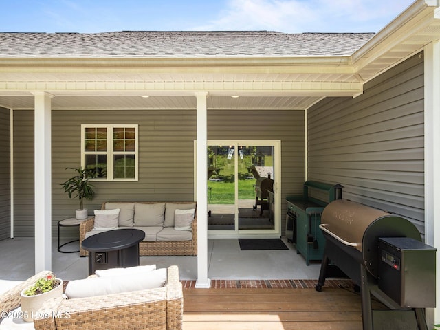 wooden terrace with outdoor lounge area and grilling area