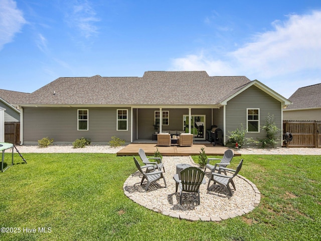 back of property with an outdoor living space with a fire pit, roof with shingles, a deck, and a patio