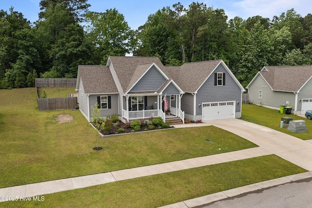 view of front of property with covered porch, driveway, an attached garage, and roof with shingles