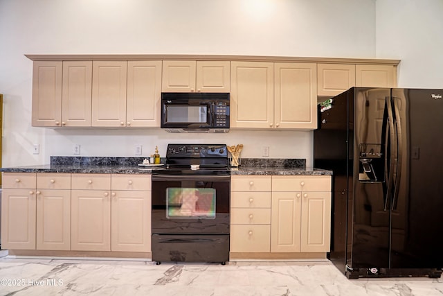 kitchen featuring black appliances, light marble finish flooring, and dark stone counters