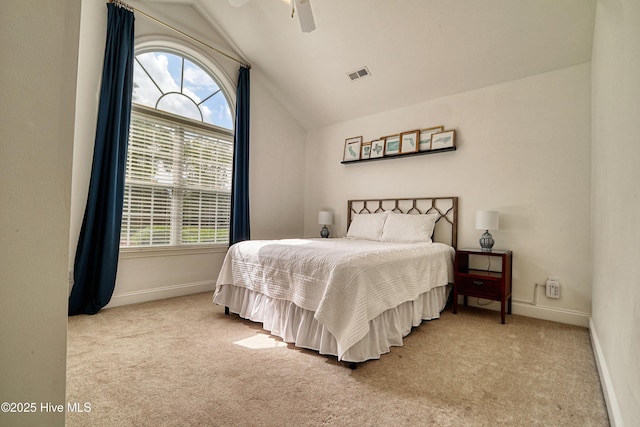 carpeted bedroom featuring lofted ceiling, baseboards, and a ceiling fan