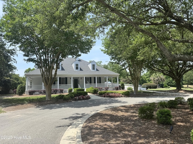 314 Gaskins Ln, Wilmington, NC 28411 - view of front of house featuring covered porch, curved driveway, and roof with shingles