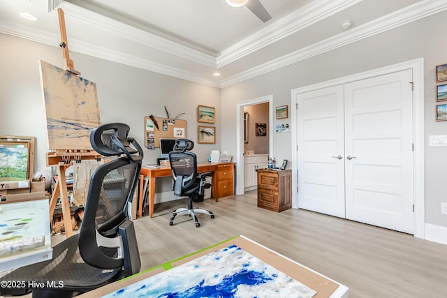 office with light wood-style flooring, crown molding, a raised ceiling, a ceiling fan, and recessed lighting