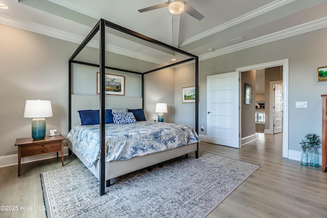 bedroom with wood finished floors, crown molding, baseboards, and recessed lighting
